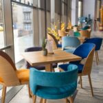 Modern cafe in loft style, black table set for coffee with brick wall. High quality photo